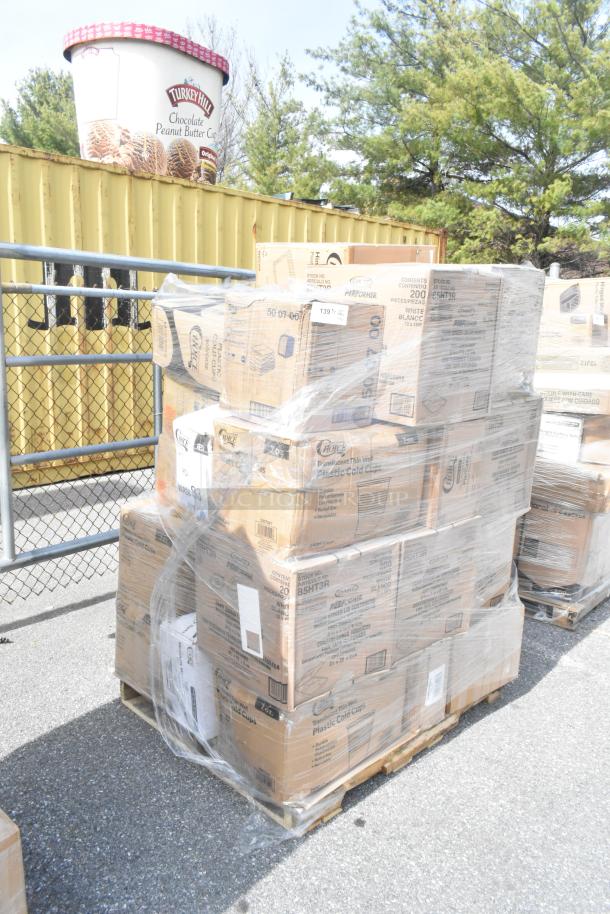 Stack of boxed items including plastic cold cups and vacuum packing pouches on a pallet, wrapped in plastic film.