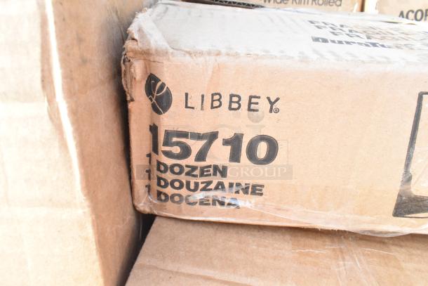 Cardboard box labeled "Libbey 15710" containing 1 dozen items; box appears scratched and dented.