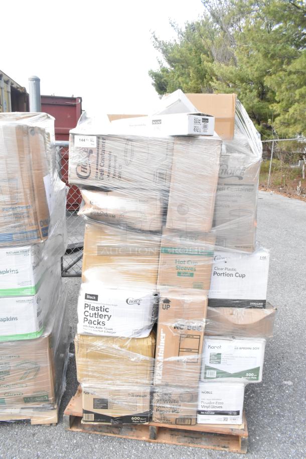 Pallet of boxed items including containers, guest towels, bath tissue, and shot glasses. Brand new, scratch and dent condition.