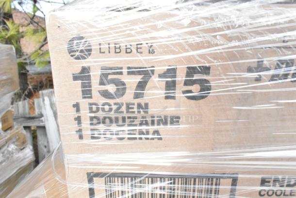 Cardboard box labeled "Libbey 15715" with "1 Dozen" markings, wrapped in plastic. Contains assorted new items.