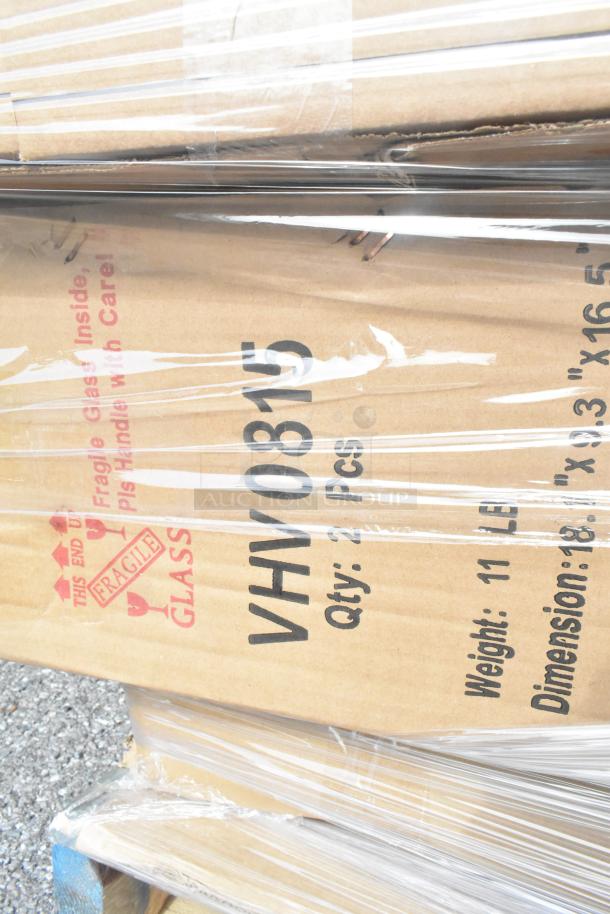 Cardboard box labeled "Fragile Glass," containing 35 new scratch-and-dent items including mop bucket and plates.