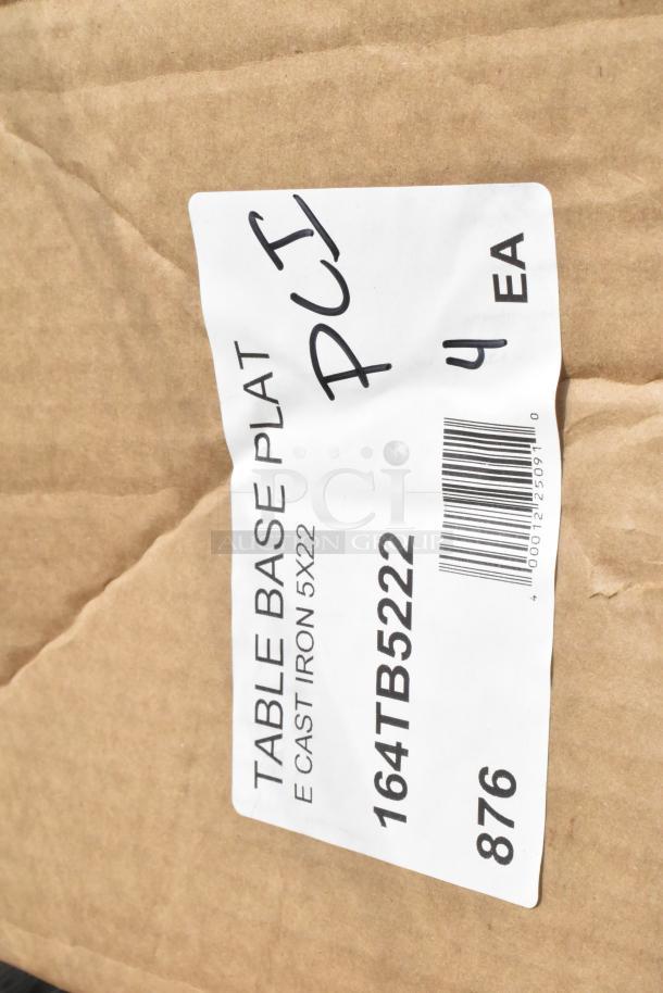 Brown package labeled "TABLE BASE PLATE, CAST IRON 5X22", code 164TB5222, 4 pieces each, part of auction lot.