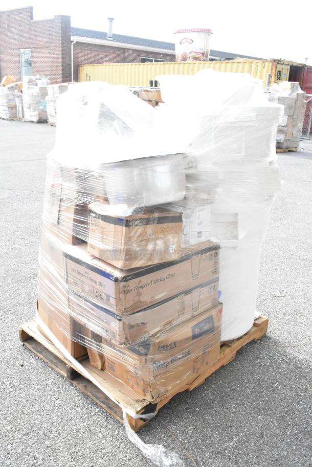 Pallet of 26 new scratch and dent items, including barstool cushions, pizza pans, tumblers, and fryer baskets, wrapped in plastic.