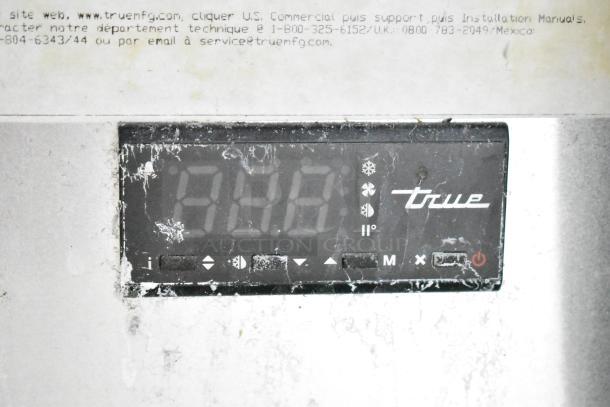 True GDM-35F-LD freezer display panel with temperature control and power button, visible signs of wear.