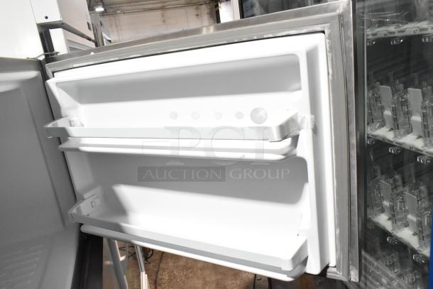 Whirlpool WRT311FZDM01 reach-in cooler with freezer, open door view, stainless steel finish, 115 volts, 1 phase.