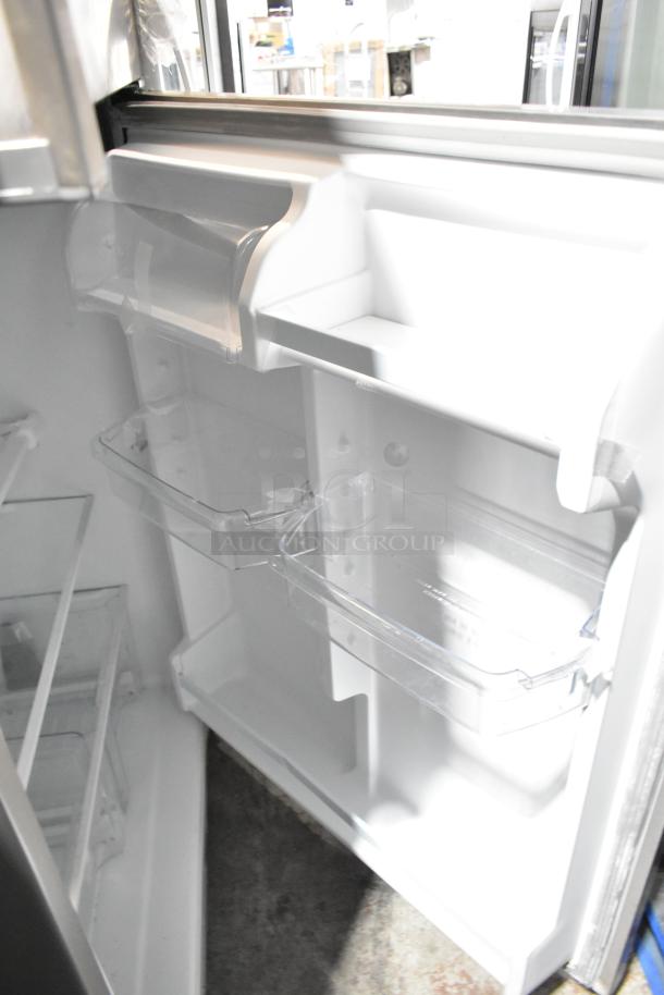 Whirlpool WRT311FZDM01 reach-in cooler with freezer, interior view showing clear shelves and bins, 115 volts, 1 phase.