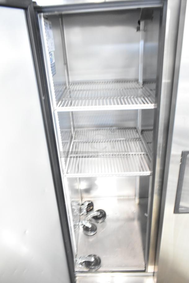 2020 True T-35-HC commercial 2-door reach-in cooler, stainless steel, 115 volts, visible interior shelving, includes spare casters.