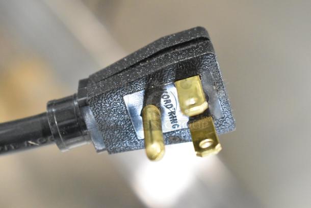 Close-up of a power plug for the True T-35-HC commercial cooler, showing three prongs and textured plug surface.