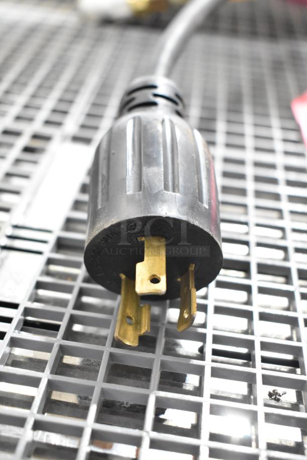 Close-up of a plug for a Nuova Simonelli Aurelia II espresso machine. Plug suitable for 208-220 volts, 1 phase.