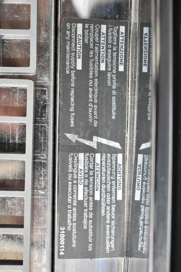 Nuova Simonelli Aurelia II espresso machine label showing safety instructions and serial number 31000114.