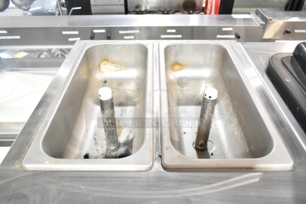 Electro Freeze SLX400E-137 soft serve machine with two bins, needs cleaning. Features commercial casters and water cooling.