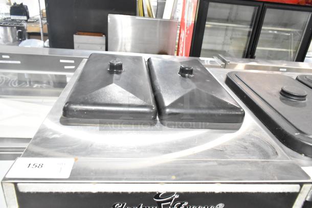 Electro Freeze SLX400E-137 soft serve machine with two black lids, stainless steel exterior, label 158 visible.