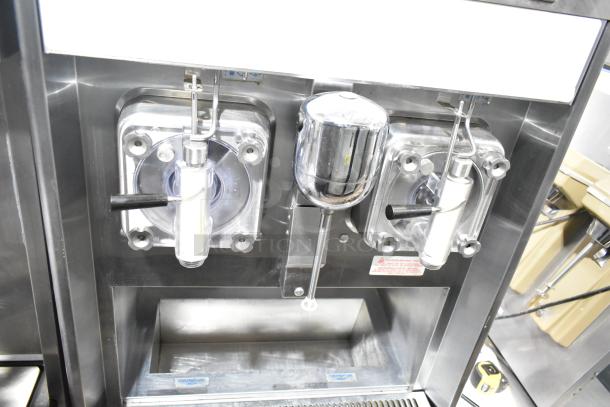 Taylor 342D-27 stainless steel commercial frozen beverage machine with two dispensers and mixer, on commercial casters.
