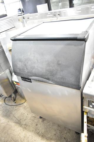 Ice-O-Matic B55PSB Commercial Ice Machine Bin, 510 lb capacity, stainless steel, black lid, visible logo, good condition.