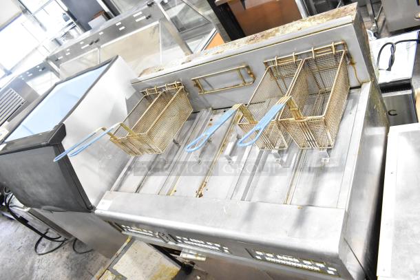 Frymaster BIGLA330-6CSD 3 bay deep fat fryer, natural gas, 105,000 BTU, with filtration system on commercial casters.