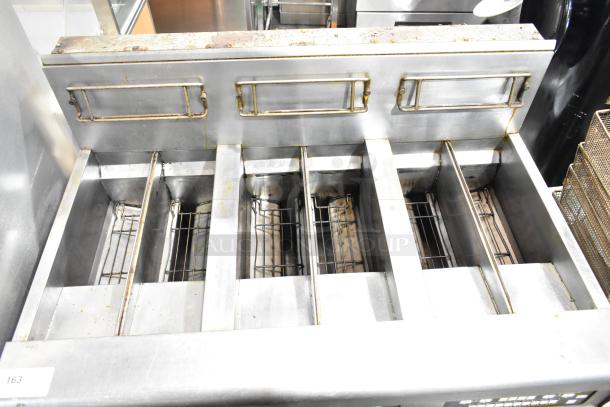 Frymaster BIGLA330-6CSD 3-bay deep fat fryer with filtration, natural gas, 105,000 BTU, on commercial casters, used condition.