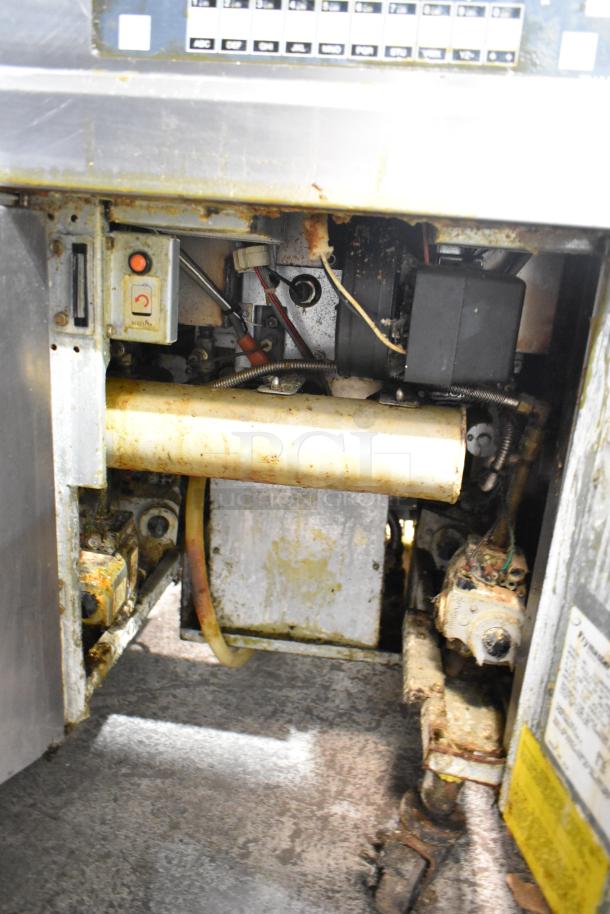 Frymaster BIGLA330-6CSD commercial fryer interior showing gas components and filtration system, moderate wear, on casters.