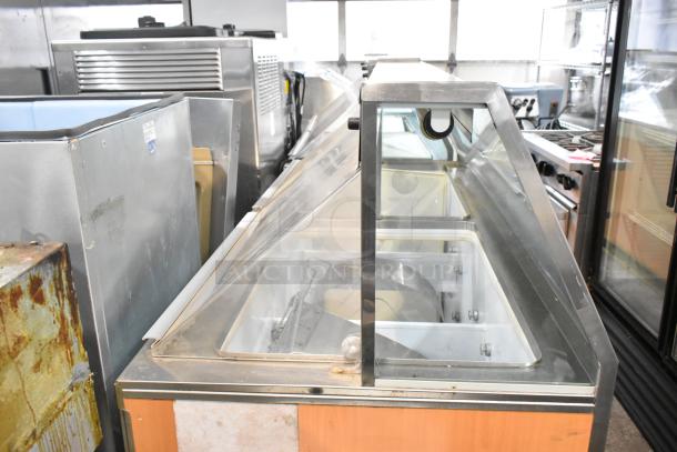 Commercial ice cream dipping cabinet with metal ice cream tub collars, 115 volts, 1 phase, visible in used condition.