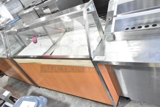 Commercial ice cream dipping cabinet with glass display, wood paneling, and metal frame. 115 volts, 1 phase, clean condition.
