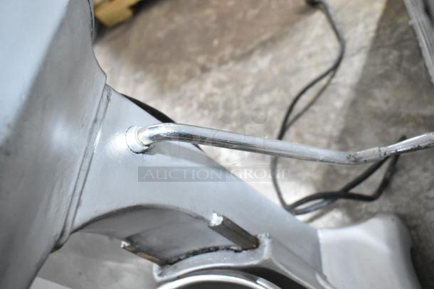 Hobart A200 commercial dough mixer detail, showing metal arm and base, 115 volts, with visible wear.