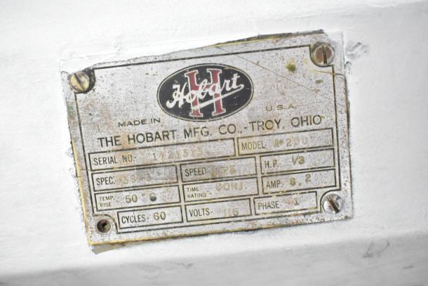 Hobart A200 mixer label showing model, serial number, 115V, and 1-phase details. Vintage wear visible. Made in USA.