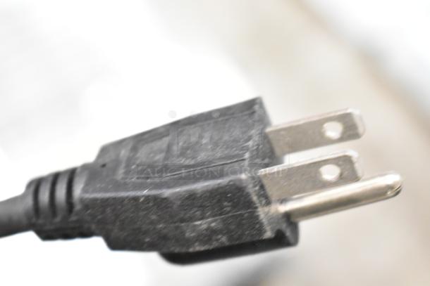 Close-up of a two-pronged electrical plug, compatible with 110-120 Volts, suitable for KoolMore HDC-1.5C display warmer.