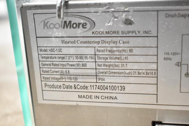 Brand new KoolMore HDC-1.5C display warmer, 1.5 cu. ft., 110-120V, curved glass, visible label with specs and model details.