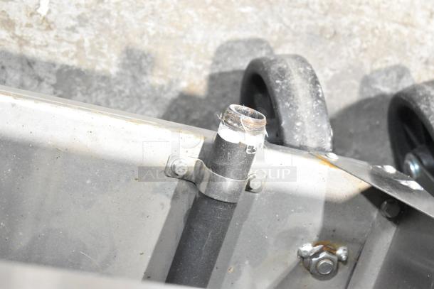 Cook Rite ATFS-40 commercial gas fryer, 102,000 BTU. Close-up of pipe connection and wheel on metal surface.