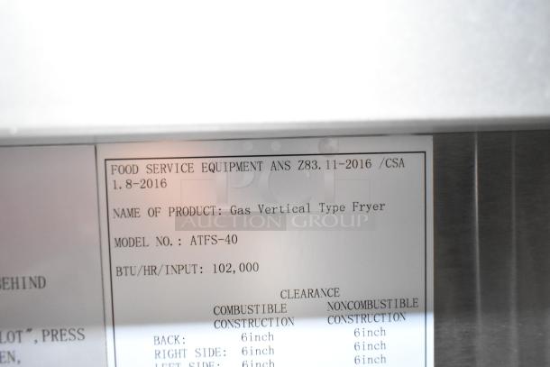 Cook Rite ATFS-40 commercial gas fryer label, 102,000 BTU, model ATFS-40, vertical type, clearance info shown.