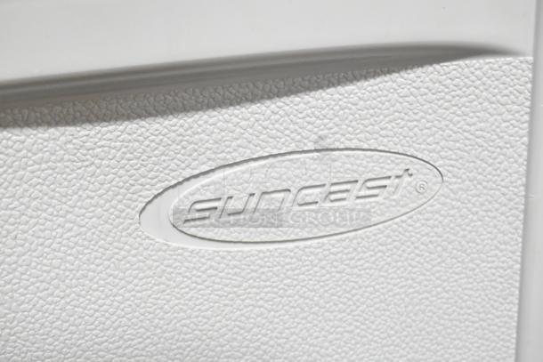 Suncast logo on white textured surface of C3600G 4 Bay Portable Sink. Mint condition, no visible wear.