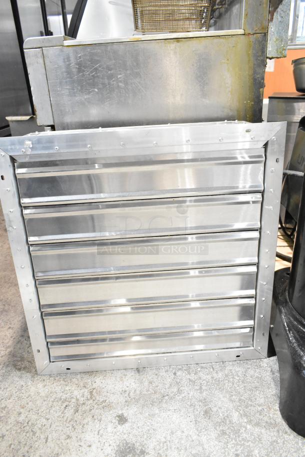 Stainless steel vent with horizontal slats, industrial-grade, slight surface wear. Suitable for ventilation systems.