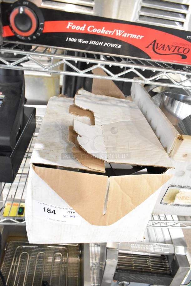 Lot including brackets, lid, extension tubes, and hose in a cardboard box on a metal shelf. Box labeled "184" from PCI Auctions.