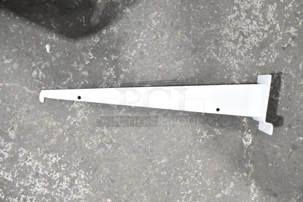 White metal bracket, new condition, with mounting holes, on concrete surface. Part of a lot including lid, extension tubes, and hose.