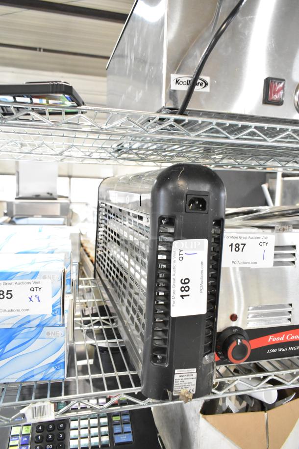 Zap N Trap Bug Zapper, 120 Volts, 1 Phase, black casing, inventory tag number 186, placed on a metal shelf.