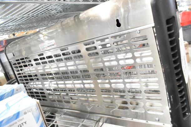 Zap N Trap Bug Zapper, 120 Volts, 1 Phase. Stainless steel case, mesh design, installed on metal shelf. Warning label visible.