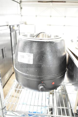 Glenray 102180 soup kettle food warmer, black, 120V, in used condition on a metal shelf. Visible label shows "189 QTY."