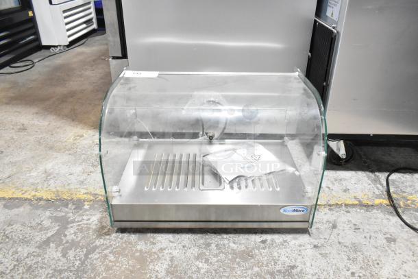 Brand new KoolMore HDC-1.5C curved glass display warmer, 1.5 cu. ft., visible tag, stainless steel finish.