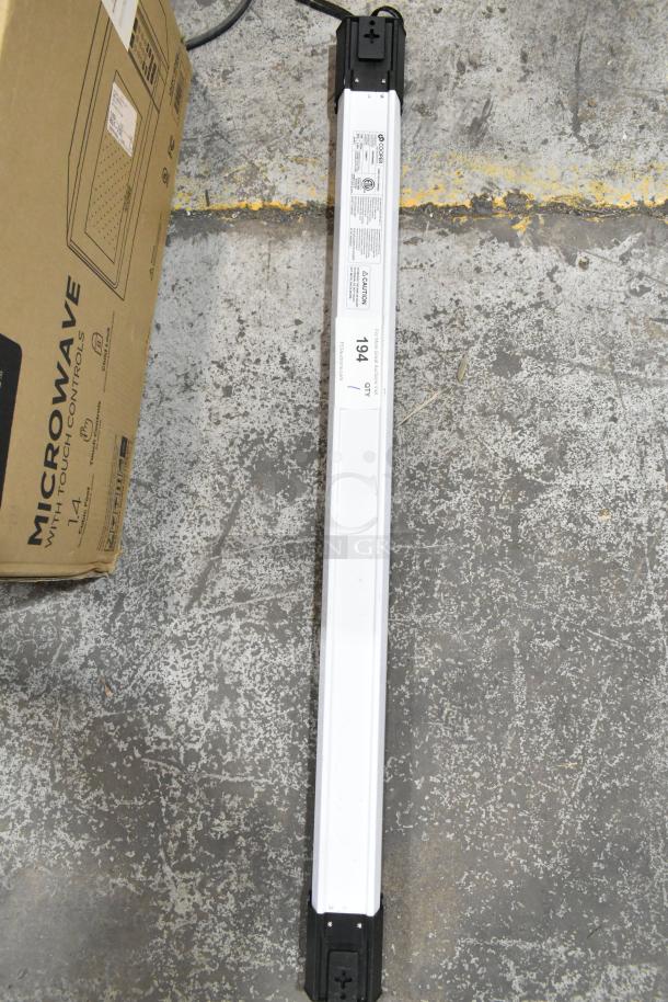 Cooper Lighting 4SHP5040RL light fixture, 120 volts, 1 phase, white and black casing, new condition, on concrete floor.