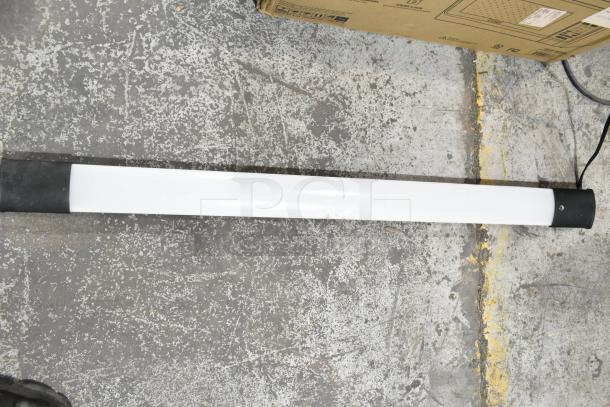 Cooper Lighting 4SHP5040RL light fixture, 120 volts, 1 phase, white casing, in used condition on a concrete floor.