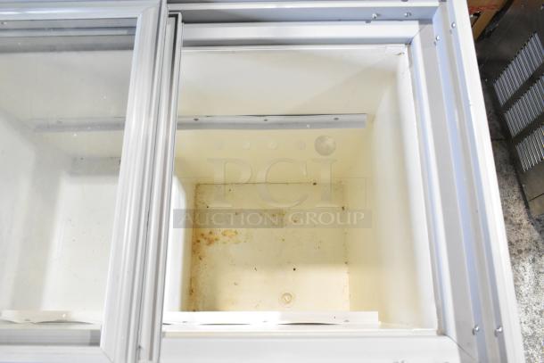 Arctic Air ST07G2 commercial chest freezer, visible interior, sliding glass top. Power: 115V, 1 phase. Used condition.