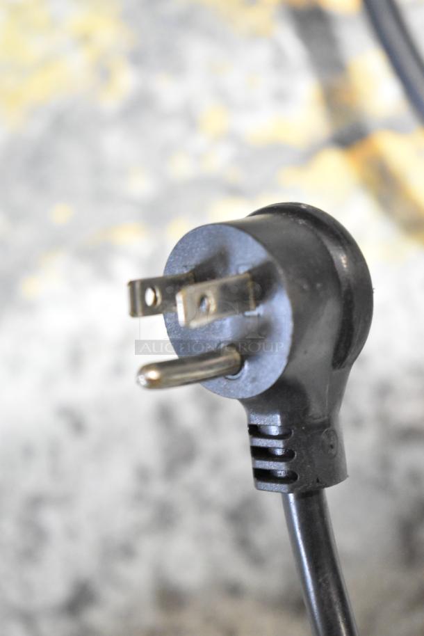 Power plug of Arctic Air ST07G2 Commercial Chest Freezer, 115 Volts, 1 Phase, black, detailing prongs and cord condition.