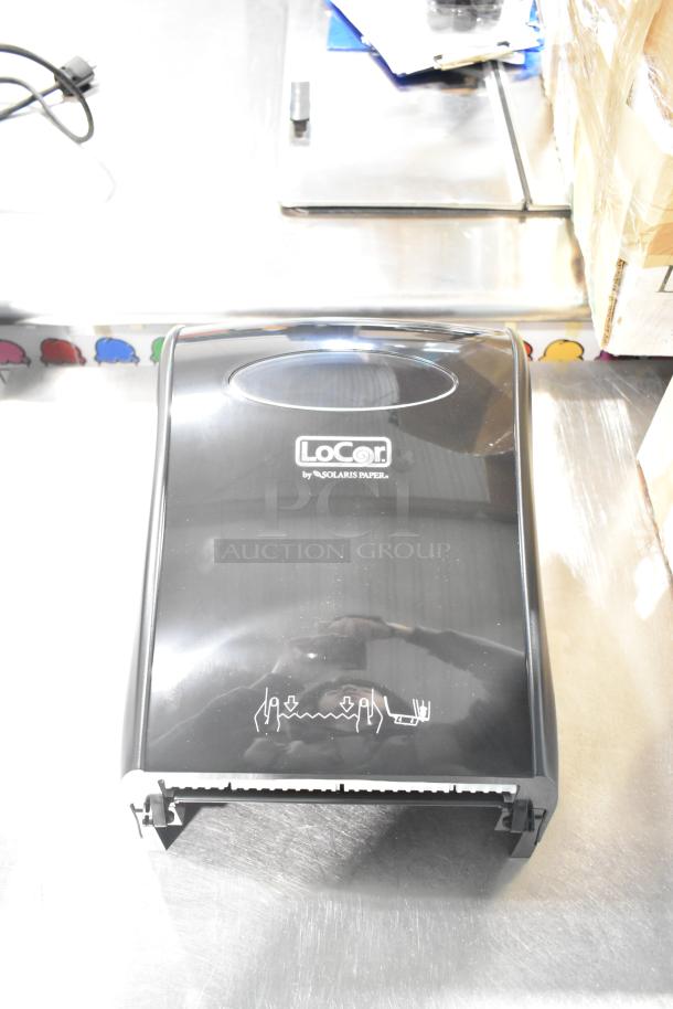 BRAND NEW LoCor D68006 wall mount dispenser with minor scratches. Black finish, Solaris Paper branding visible.