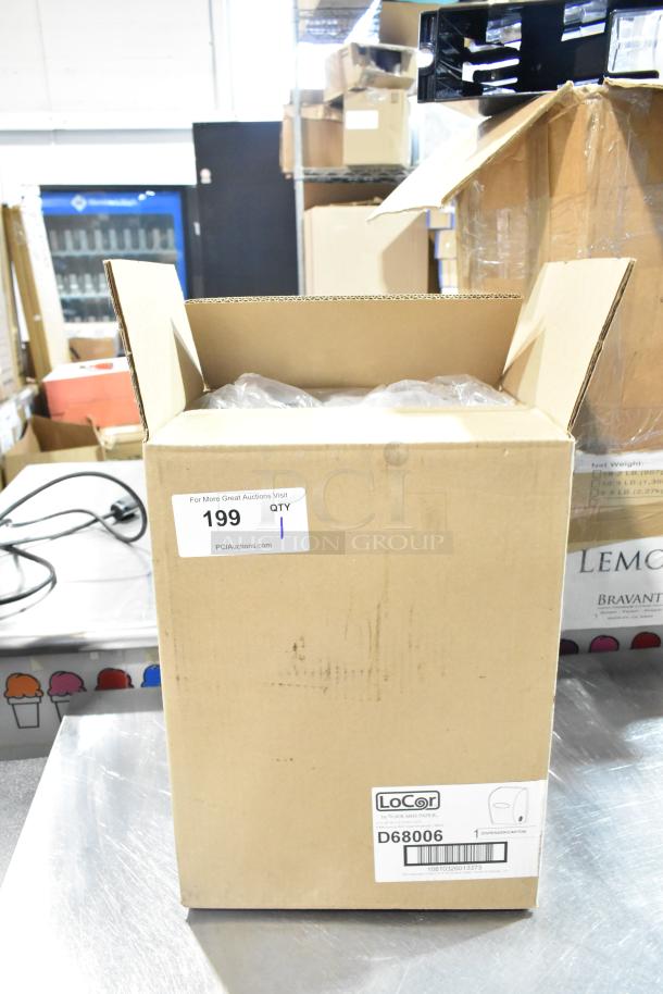 Brand new LoCor D68006 wall mount dispenser in box, labeled "scratch and dent." Cardboard packaging with visible markings.