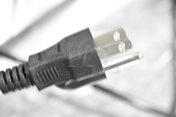 Close-up of a power plug, possibly for a commercial countertop waffle cone maker, 110 volts, 2 phase.