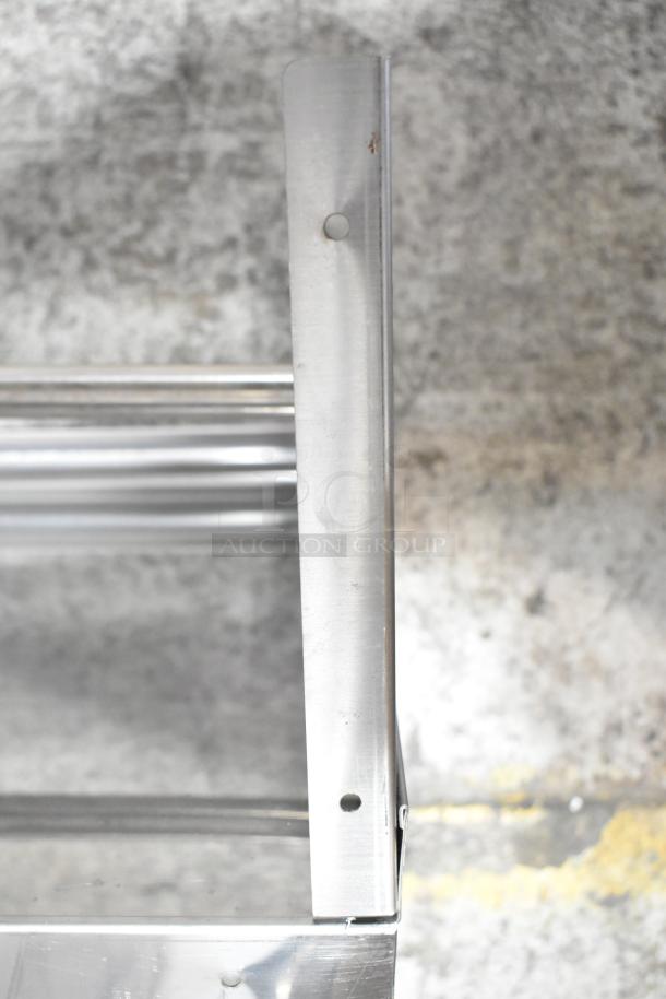 Stainless steel wall mount shelf with visible screw holes, modern design, and a sturdy support bracket.