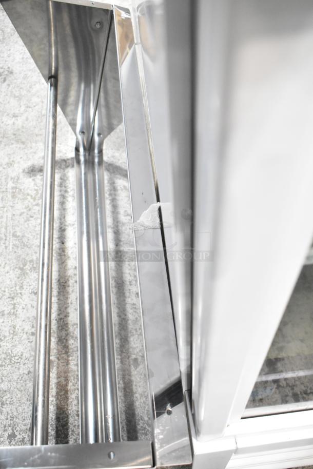 Stainless steel wall mount shelf with a sleek design. Visible scuff on the surface. Modern and durable.