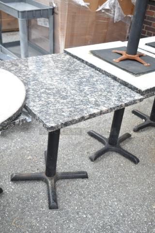 13 dining height tables with granite tops and metal bases, varying shapes and sizes, suitable for restaurants. Auction lot.