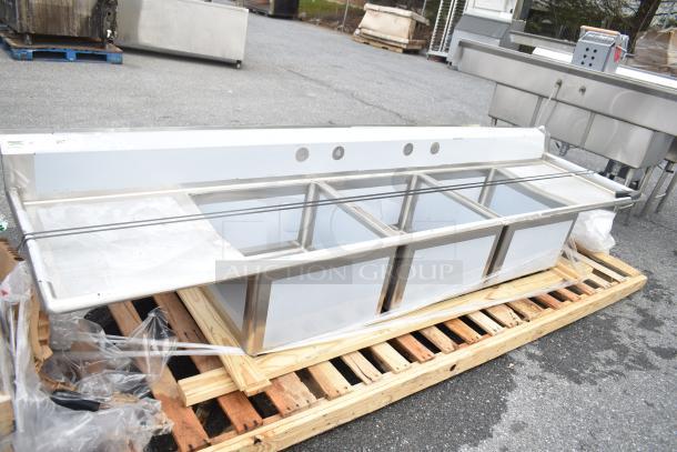 Brand new Regency 600S32424224 commercial 3 bay sink with dual drain boards, minor scratches, on wooden pallet.