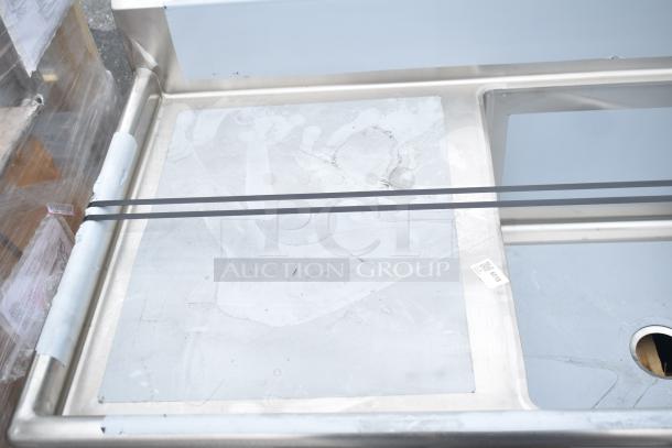 Brand new Regency 600S32424224 commercial 3-bay sink with dual drain boards, minimal scratches visible.