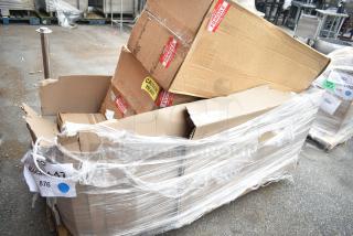 Cardboard boxes labeled "Fragile" and "Caution Heavy," containing 3 new scratch-and-dent bar stools, wrapped for auction.